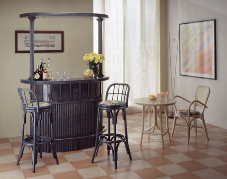 Single shot photo of a room with a rattan bar cabinet