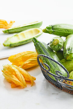 Zucchini blossoms and zucchinis in a kitchen setting