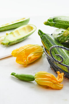 Zucchini blossoms and zucchinis in a kitchen setting