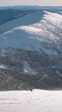 Ski mountaineer descending san lorenzo peak in la demanda