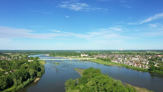 Scenic aerial view of Sully sur Loire with the Loire River, lush greenery, and a picturesque town under a clear blue sky.
