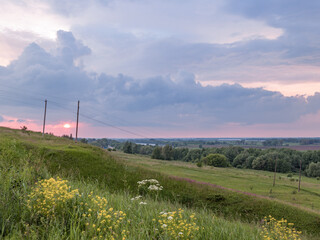 Beautiful sunset over a field of grass and flowers