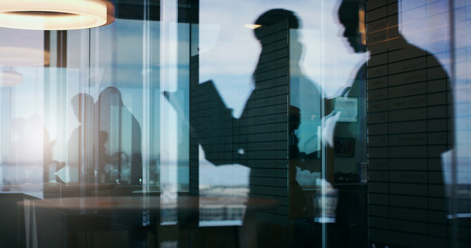 Silhouette, reflection and support with business people in office for planning, b2b and realtor advisor. Collaboration, discussion and window with employees for partner, team and property developer