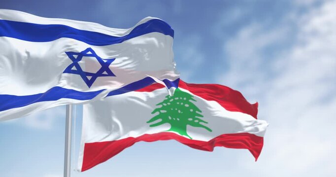 Flags of Israel and Lebanon waving in the wind on a clear day