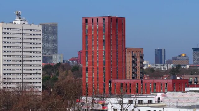 Aerial video of Birmingham Skyline with an Airplane flying over. 