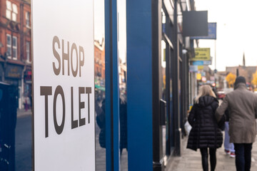 Shop To Let sign on high street window