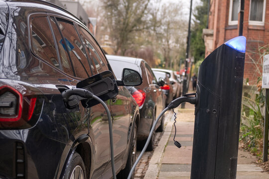 An electric car on-street charging on residential street