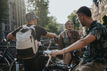 Naklejka premium Three friends with bicycles laugh and chat on a canal bridge in Amsterdam. A casual urban moment of friends socializing by bikes and water in a Dutch city.