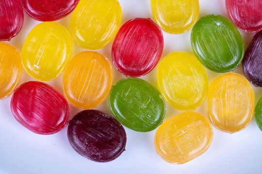 Unique studio photograph highlighting detailed craftsmanship of candies. Artisanmade selection featuring brightly flavored confections showcased in intimate studio setting
