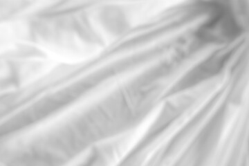 Obraz premium Close-up of white fabric texture with soft natural wrinkles and subtle woven textile pattern. Minimal neutral cloth background suitable for design, fashion, and abstract texture concepts.