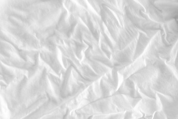 Obraz premium Close-up of white fabric texture with soft natural wrinkles and subtle woven textile pattern. Minimal neutral cloth background suitable for design, fashion, and abstract texture concepts.