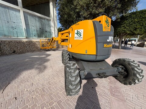 Mallorca, spain, february 20, 2026, haulotte jfs cherry picker boom lift parked on paved area near building, industrial aerial work platform equipment