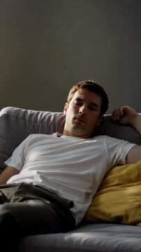 A contemplative young man lounging on a sofa, shifting from a state of alertness to relaxation, showcasing the passage of time and the journey of thoughts in a serene setting.