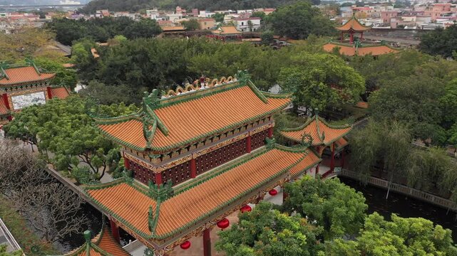 Rising drone shot of temple complex in classic Chinese garden in Guangzhou