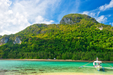 PALAWAN, PHILIPPINES - DECEMBER 21, 2023: Tropical islands  in El Nido on Palawan Island in the Philippines. 6 million tourists visited Philippines in 2016. On a hot sunny afternoon. Beautiful scenery