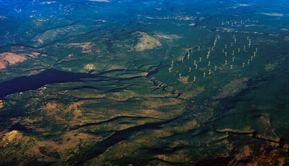 Bird's eye view of wind turbines farm in mountain range. © M-Production