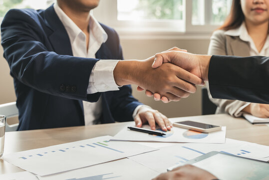 group of successful business people meeting. client and suppliers shaking hands after deal agreement completed.