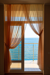 Fototapeta premium Luxury resort room door to the breezy waterfront terrace with ocean view, Mediterranean sea, Europe