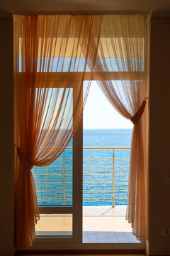 Luxury resort room door to the breezy waterfront terrace with ocean view, Mediterranean sea, Europe