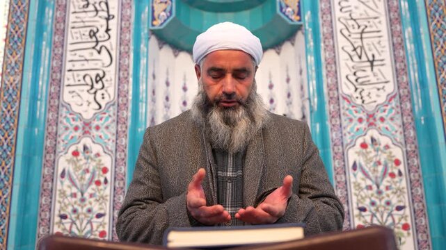 A Muslim sheikh praying in the mosque during Eid al-Fitr. Worship during the month of Ramadan. Concept of Islamic holidays.