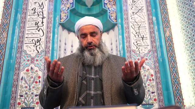 A Muslim sheikh praying in the mosque during Eid al-Fitr. Worship during the month of Ramadan. Concept of Islamic holidays.