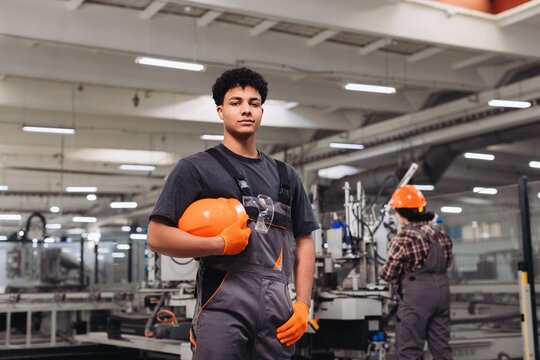 Young worker standing confident in manufacturing factory