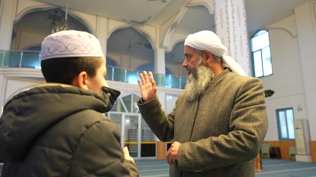 A Muslim sheikh hugging children in a mosque and congratulating them on the occasion of Eid al-Fitr. Islamic holidays. Muslims celebrating Eid al-Fitr after the end of the month of Ramadan.
