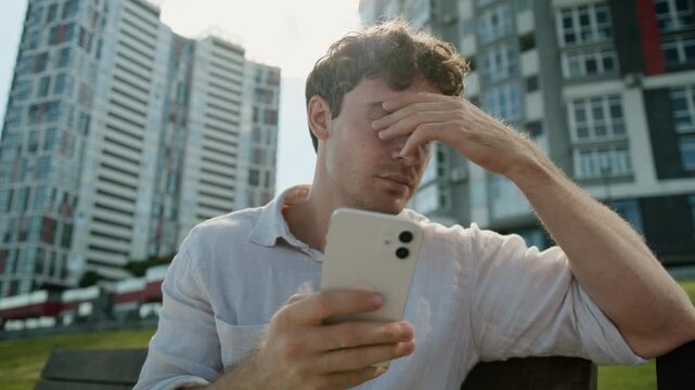 Stressful disappointed Caucasian business man with mobile phone businessman male guy suffering with smartphone fail error connection lost money online betting failure agent specialist upset in city