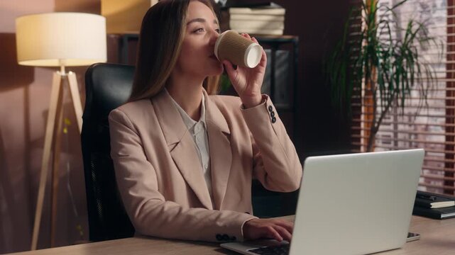 Caucasian business woman typing laptop cyberspace drinking coffee at table in office businesswoman working computer drink tea latte cappuccino enjoy beverage browsing internet female girl agent work