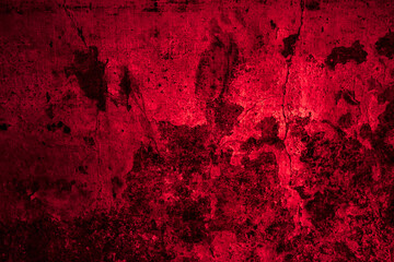 An aged red grunge background featuring a dark textured wall design with a rusty vintage paint pattern for a rough artistic backdrop © shan
