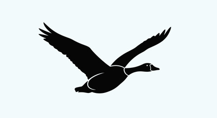 Black silhouette of a flying goose. © MUHRODIN