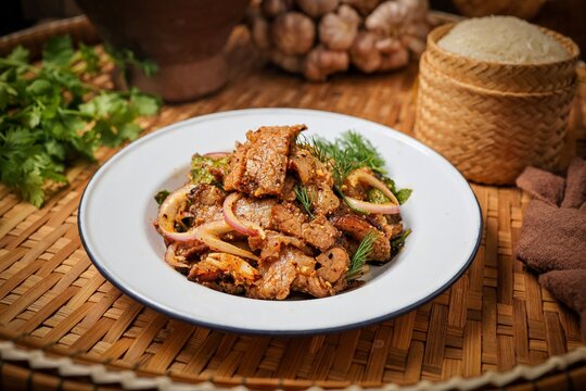 Traditional Thai Spicy Grilled Pork Salad (Nam Tok Moo) with Sticky Rice