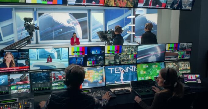 Cable News Control Room Runs a Live Studio Newscast, With Producers Switching Camera Views, Coordinating Broadcasting, Professional Anchor, Shows, Sports Segments for a TV Station Channel Stream.