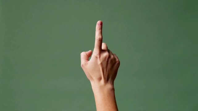 Hand Gesturing with Fingers Crossed Against Green Background gesture superstition