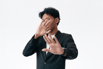 Confident Man in Black Blazer Gesturing Stop With Open Hands In Studio Portrait