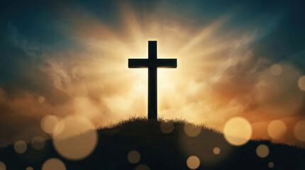 Silhouette of cross on hill with radiant sun behind