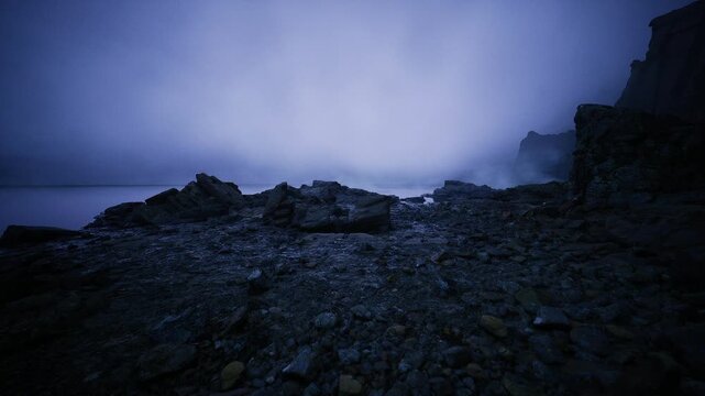 Misty seaside evening. Foggy coast with calm waters. Shrouded shoreline under dim twilight glow. Atmospheric grey beach with distant cliffs and gentle waves