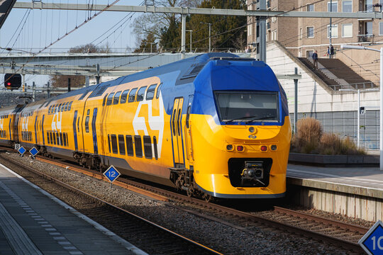 Arnhem, Netherlands - February 26 2026: Nederlandse Spoorwegen NS yellow double deck train at Arnhem Centraal station Netherlands