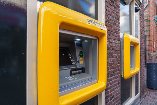 Arnhem, Netherlands - February 26 2026: Geldmaat ATM cash machine installed in brick wall along street in Arnhem, Netherlands