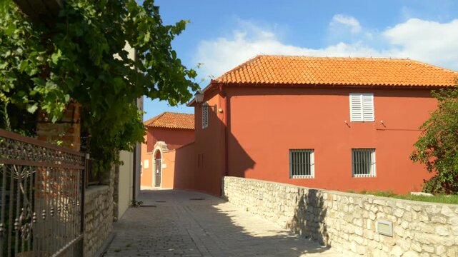 Sunny street with Mediterranean houses and orange roofs Croatia