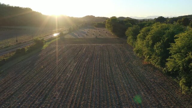 backlight view of a threshed field. Italy