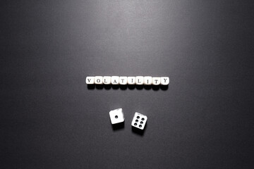 Volatility word above dice symbolizing market fluctuations, financial instability, and...