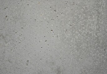 Fototapeta premium Abstract close-up of a weathered gray concrete wall surface. Rough, rugged, and aged industrial material suitable for background design, template, material, rock