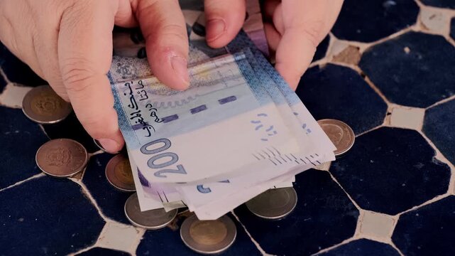 closeup Moroccan dirham money, coins on traditional table, count paper dirham banknotes, cash payments, monetary savings, save for vacation, exchange and cashing currency