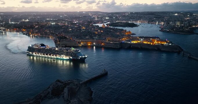 Malta, Valletta - 11.10.2025: Cruise luminous ship leaves the port of Valletta at night. Malta 