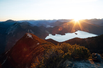 Fototapeta premium Spectacular Summer Sunrise from a Mountain Peak, Panoramic View over Jagged Alpine Ranges in Golden Morning Light