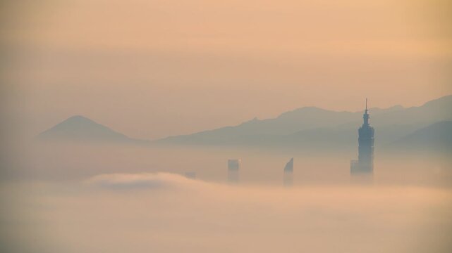 A scenic view of Taipei building rising above a sea of clouds during a misty sunrise, captured from Datong Mountain in New Taipei City, Taiwan.