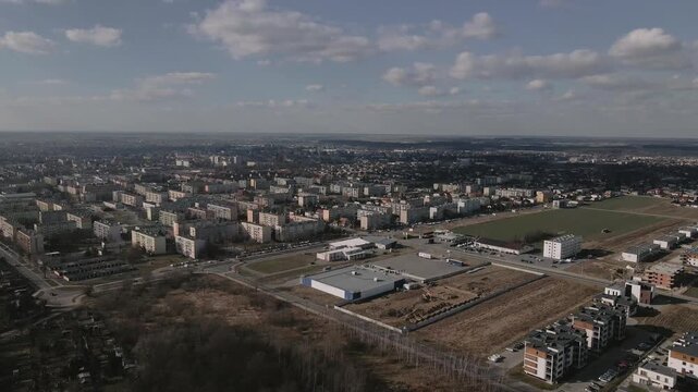 Aerial high-angle view overlooking a modern apartment complex and commercial zone in Ostr&oacute;w Wielkopolski