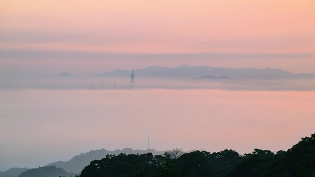 A breathtaking sunrise view of Taipei 101 emerging from a sea of clouds, seen from Datong Mountain in New Taipei City, Taiwan.