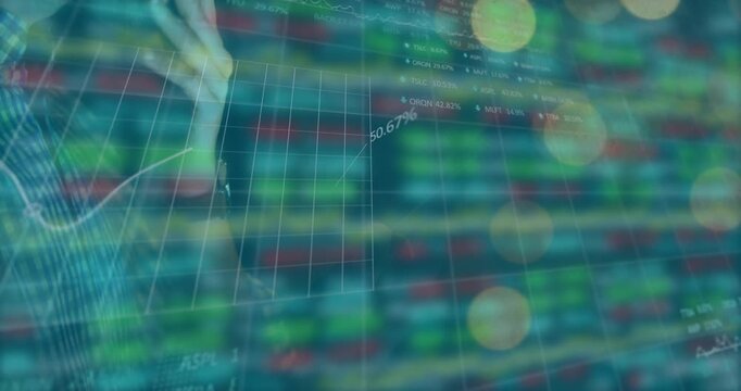 Male analyst hand hovering, tracing finance line on glass display highlighting % values and tickers